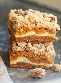 These Cream Cheese Pumpkin Praline Bars are made with moist pumpkin cake, filled with cream cheese filling & topped with a buttery praline crumble! #creamcheese #praline #pumpkinbars #creamcheesepumpkinbars #pumpkindessert #pumpkinrecipe #easypumpkinbars #bestpumpkindessert