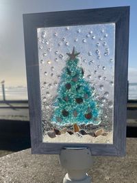 Sea glass, seashells, star fish sun catcher window in a white wood 5x7 frame (pedestal not included)