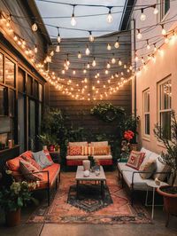 This enchanting patio features a stunning array of string lights that create a magical evening setting. Vibrant colors and lush greenery. Tap the image for more.