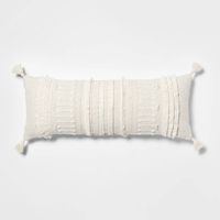 The Oversized Oblong Woven Knotted Fringe Decorative Throw Pillow from Threshold™ is sure to add tasteful style and plenty of comfort to your space. Boasting a 100% cotton shell that feels gentle to the touch, this decorative throw pillow also features a soft polyester fill for comfortable sitting and lounging. The rectangular pillow showcases a cream vertical woven-stripe pattern with knots and fringed accents, along with matching tassels on each corner for added flair. Combine with other embro