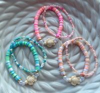 Each set comes with 1 clay bead bracelet and 1 seed bead bracelet. You can choose from our turquoise, pink, and peach set. The clay bead mix bracelets come with a beige turtle charm, and faux pearl beads. The seed bead mix bracelets are made with glass seed beads.