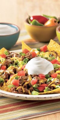 Make your Taco Tuesday feel like a Friday fiesta with these easy Loaded Beef Nachos! Loaded with tortilla chips, cheese, green onion and Daisy Sour Cream, this tasty dish is sure to be a crowd pleaser.