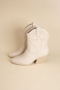 Get ready to heat things up in these Troy Western Boots! With a casual style and western flair, these booties are perfect for any occasion. Featuring playful embroidery and a closed, pointed toe, you'll be stepping out in style. Don't miss the block heel, adding a touch of fun to these synthetic beauties!Care instruction: Use a soft cloth and a little lukewarm water to clean the footwear after use. If necessary, add a small amount of mild soap. Carefully wipe off soap residue with a damp cloth.Material Composition: Synthetic