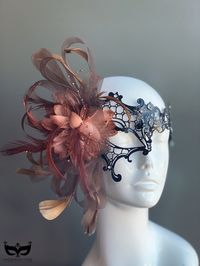 Classy Venetian style black metal mask with rhinestone detail and a beautiful floral feather. This masquerade mask will complement any outfit and is perfect for elegant formal events! Choose from five different colors for the floral feather! S H I P P I N G ** Please leave a checkout note with your need date & contact number, especially for expedited and custom orders ** Processed same day or within 24 hours.  1-2 day guaranteed delivery services are offered, add items to your cart and click on