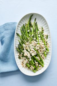 Crumble matzo over this easy asparagus side dish for a satisfying crunch. Lemon and chopped chives add a burst of freshness, while honey adds a touch of sweetness.