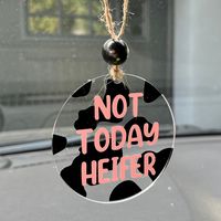 "Join my Facebook VIP page for exclusives, sales, giveaways and more! https://www.facebook.com/groups/1127737197769384/ Not Today Heifer Car Charm Add some fun accessories to your car with this funny car charm, attached to your rear view mirror and wait for the compliments!  Pink wording Black Cow Print Black Wood Bead  Twine  3\" round acrylic  Shipping Information U.S. orders ship once a week on Saturday after processing times.  Items are made after order is placed so processing times vary depending on size/quantity ordered.  Each piece is made to order. I will work fast while maintaining quality to get your order filled and to you ASAP. Most of our items are shipped within 1 week but can take longer due to demand, availability of supplies. We ship via USPS which typically takes 3-4 busi