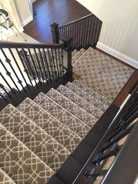 Patterned Stair runner.  Staircase.  Wrought Iron Banisters.  Wood Newel Posts.  Carpet Stairs. Stanton's Equinox.