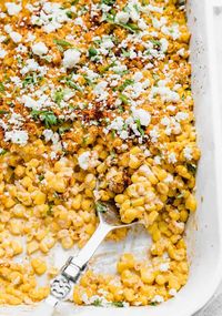 Rather than make Mexican street corn on the cob, we're turning it into a casserole. Loaded with cojito cheese, chili powder, and cilantro this Mexican street corn casserole is an easy Mexican side dish you can make to enjoy alongside so many main course meals! It would pair perfectly with steak tacos, enchiladas, fajitas and more! the perfect side for any Mexican meal.