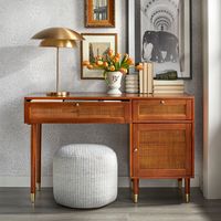 Bring a new level of sophistication to your home office with the angelo:Home Allen Desk. Inspired by midcentury-modern designs, this stunning desk is defined by its cane accents and rich walnut finish.