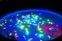 glow sticks in the pool. Pool Party Sweet 16 decoration