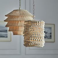 The Point Dume Pendant in Small from Palecek features wood spheres in a cream finish hand-sewn together over a metal frame. This elegant pendant comes with a cream-finished chain and canopy hanging kit. This hanging light is perfect to add a touch of coastal elegance to entryways, living spaces, and bedrooms alike. *Professional installation recommended.