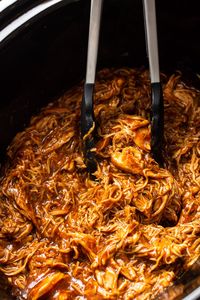 This is the best BBQ pulled chicken recipe! It's easily made in your slow cooker for tender and juicy shredded chicken that makes the most amazing sandwiches.