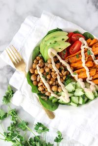 Dive into this delicious Roasted Chickpea Goddess Bowl! This folate rich Roasted Chickpea Goddess Bowl is a delectable and filling vegetarian dinner idea. Crunchy chickpeas with sweet potatoes, veggies topped with tahini dressing makes a super satisfying dish.YUM!