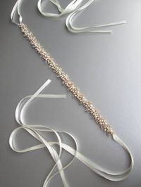 This belt is made with the finest Swarovski crystals and pearls neatly twisted to form this unique floating effect crystal belt. The belt measures 1 1/8 wide and 25 long and is tied in the back with four petite ribbons. The entire sash with the ribbons measures 150 long. Available in