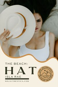 The Isla Rae panama style hat with exaggerated brim will shade your eyes for endless walks on the beach and pool time lounging. It's natural color and modern design will become your new favorite accessory under the sun. Features a handcrafted bronze multifunctional pin with quartz and agate gemstones.