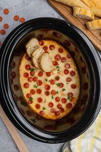 Overhead look at crock pot pizza dip with bread on top