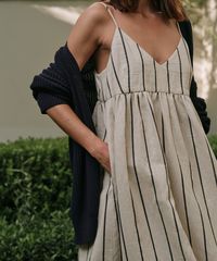 Cove Dress Natural/Navy Stripe Easily thrown on for an instantly put-together look, this dress is the definition of seasonal ease. With a relaxed fit and perfectly placed pockets, wear it to brunch or the beach for an element of casual flair in your everyday. 47% Polyester 32% Cotton 21% Linen Made in China of Italian Fabric. Slight v-neck ankle length dress with pockets.