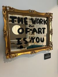 The purpose of this art Is to remind ourselves that we truly are a work of art.  Self love is the foundation of manifestation and one of the most important things to do in life.  The words "The work of art is you " is written in black paint on this vintage looking mirror.