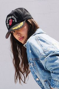 Add a versatile, vintage-inspired touch to your hat collection with this trucker version featuring defined Rolling Stones embroidered logo at front and leaf detailing at sides for an added classic feel. **Features:** Trucker style, defined embroidery, adjustable fit at back, staple 6-panel design **Why We ❤ It:** Forever cool and classic, this wear-anywhere trucker hat is the true definition of an effortless essential. | Rolling Stones Trucker Hat by American Needle at Free People in Black