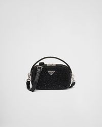 All-over synthetic crystals Handle with synthetic crystals Detachable, adjustable nappa leather shoulder strap, length 115 cm Metal hardware Enameled metal triangle logo on the front Zipper closure Nappa leather interior