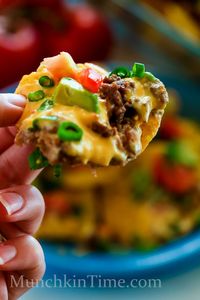 You will love 8 Ingredient Nachos Madness Recipe - made of tortilla chips, ground beef, cheese, tomatoes, avocados, green onion, and refried beans.