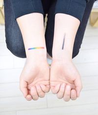 Spectrum tattoos on the wrist.