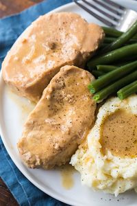 Perfect, tender, and juicy smothered crock pot pork chops are an easy Sunday dinner. You are going to love my slow cooker pork chops!