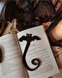 Want to adopt a Bat bookmarker?? Whether you're reading a horror novel or a cozy mystery, this crochet bat bookmark is a must-have whimsigoth accessory! Order yours today and enjoy the convenience of a bookmark that's as cute as it is practical - Whimsigoth - Cute - Practical - Soft - Elegant 🧶WHAT IS IT MADE OF: Made from 100% Acrylic yarn. each bookmark measures at 12 inches in total length. Each bat will be unique from each other from the wings to the position of the eyes. Eyes are pearl white beads and in the center of the bat it will have a read crystal bead. 🦇Colors: -Black -Beads: Pearl white, Crystal Read ------- The perfect addition to your spooky reading collection - a handmade crochet bat bookmarker with hand-sewn beads! This charming little accessory is not only functional bu