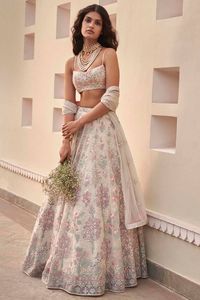 Featuring a natural colored lehenga in organza silk base with pockets and embroidery. It is paired with a matching blouse and a pure nylon dupatta.    FIT: Fitted at bust and waist.  COMPOSITION: Organza silk, Pure nylon.  CARE: Dry clean only.