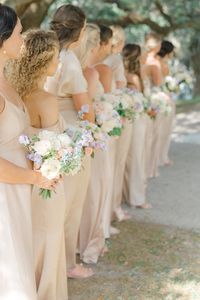 Spring bouquets and champagne bridesmaids dresses.