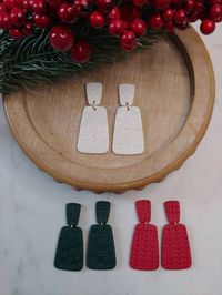 Red, White, and green textured polymer clay dangles.  Red with sweater pattern, white with snowflake pattern, green with holly pattern.