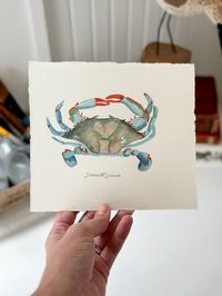 A mini Blue Crab, swimming the tides into your home. All the Fine Details: Original painting is watercolor and gouache, painted on 140 lb. cold press Arches watercolor paper, 6.5" x 7.5" (painted crab is approximately 5.5" x 4" Fine art prints (unframed) are printed professionally and locally in St. Petersburg, Florida, printed on Cold Press Bright White (21 mil, 340gsm), acid free, 100% cotton rag paper with a bright white, textured surface. High quality pigment ink archival to 200 years (or yo