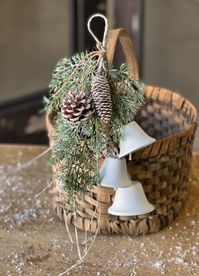 Birch Tipped Cedar & Bells Hanging | 14" A wintery collection of cedar, pine cones, printed birch-like filaments, with a dusting of mica, glitter, and light snow. Ornament comes with metal bells. materials: plastic, natural pine cones, glitter, mica, light snow, printed filaments, paper wrapped wire base, metal bells this listing is for the item above only - all other items are used for styling purposes only