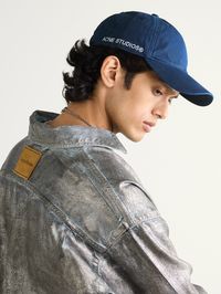 Acne Studios' 'Carliy' baseball cap is made from cotton-twill in a blue hue. In keeping with the pared-back aesthetic the label is known for, it's minimally detailed with the brand's moniker at the side.