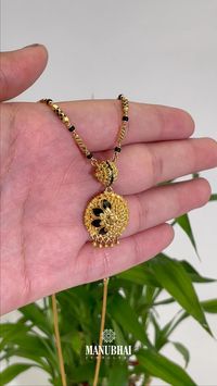 Unique Floral Pendant Gold Mangalsutra featuring black meenakari work. The floral pendant adds a touch of tradition and sophistication to your ensemble.