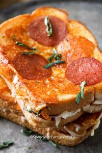 In this pizza grilled cheese recipe, a classic grilled cheese sandwich is updated with pepperoni, pizza spices, and toppings then fried to crispy ooey gooey perfection.