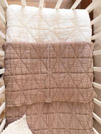 Bundle your baby in luxurious comfort with our quilted crib blanket by New Grain. It's both a practical item that you can reach for again and again as well as a beautiful, heirloom-quality addition to your baby's nursery. Available in four colorways, this blanket measures 50" x 30" and is made of 100% organic cotton with recycled polyester filling.