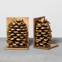 Bring some rustic charm and eye-catching appeal to your decor with these Pinecone Decorative Bookends from Hearth & Hand™ with Magnolia. Made from lightweight aluminum, these two gold decorative bookends are shaped like pinecones for a unique touch of style. Add them to your library or home office as an easy way to help keep your books organized.Celebrate the everyday with Hearth & Hand — created exclusively for Target in collaboration with Magnolia, a home and lifestyle brand