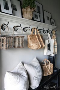 If you do not have room for a mud room.. How about a wall of hooks with a ledge above to have a mini gallery wall....photo credit to| Holly Mathis Interiors