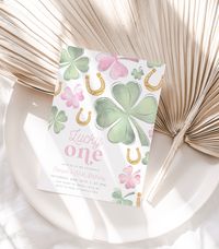 "Celebrate your little one's first birthday in style with our Lucky One Birthday Invitation Girl Printable. Featuring a unique shamrock design with green and pink clovers and golden horse shoes. Use our self editing template to customize all the verbiage to fit your event needs. ✅ INSTANT ACCESS ✅ NO EXPIRATION DATE ✅ Edit All Verbiage ✅ Edit Font Style ✅ Edit Font Color ✅ Edit Font Size INSTANT DOWNLOAD - Access your template within minutes of purchase and edit in Canva - A FREE fully customizable template editor that allows you to personalize your printable file. No software to install or fonts to download. You will need to create a FREE Canva account. SPECIFICATIONS FINISHED SIZE: 5\" x 7\" DOWNLOAD OPTIONS: * PDF - for home printing, copy center or print shop  * JPG - Digital Download