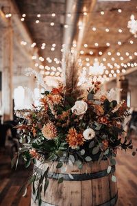 Start with larger flowers first, then add in feathery accents, dark green leaves, and your smaller flowers for a fuller flower arrangement look. Journeyman Distillery I Emerald Image