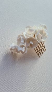 Style your glamorous waves or romantic hair up with a beautiful and delicate 'Stela' hair comb. Made with intricately hand-sculpted flowers of light and durable clay. Finished with gold or silver rhinestones, or freshwater pearls. Attached to golden or silver hair comb. The length of a hairpiece is about 9 centimetres. Sent beautifully packaged in Medze Bride gift box. As 'Stela' hair comb is made to order I cannot accept refunds/exchanges. But if you have any problems with your order please ema