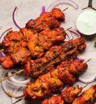 Tandoori marinade on chicken tikka skewers.