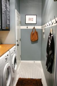 simple inexpensive very narrow laundry room with what looks like a piece of plywood on top the appliances for a makeshift but workable folding space. love the blackboard paint cupboards