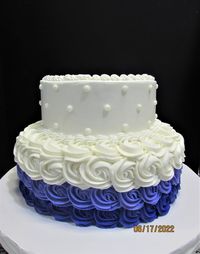 Two tier buttercream cake with rosette bottom and dot design top