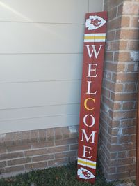 "Kansas City Chiefs Welcome sign. I make each sign out of fence wood and hand paint each logo. Everything on the sign is hand painted. Weather proofed. Measures 6 ft tall X 7 inches wide. Perfect for any front porch, garage or yard decor. I can do any logo or team and can customize the saying coming down ( example \" home sweet home\" \" last name \" ) red background or brown background is pictured. I can do any color background as well ( grey, darker brown, natural wood color )"