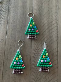 Get into the holiday spirit with these festive Christmas Tree Pony Bead Keychains. Great for book bags, keys, or even as an ornament for your tree.  Measures: 4.5 in x 2 in