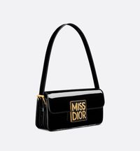 Unveiled At The Autumn-winter 2024-2025 Fashion Show, The New Miss Dior Flap Bag Redefines House Staples Of Modern Elegance. Crafted In Black Patent Calfskin, It Has A Timeless Aesthetic Contrasted By A Modern Enamel Plate With The Collection's Hallmark Miss Dior Graffiti Signature. The Flap Reveals A Main Compartment Completed By A Zip Pocket To Accommodate All The Essentials. Thanks To The Adjustable Strap, The Bag Can Be Worn Over The Shoulder For A Contemporary And Couture Style..