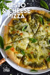 There is no steadfast rule that states pizza must be prepared with tomato sauce and the proof can be found right here in this Pesto and Cheese Pizza recipe! Start with a quick and easy homemade pesto sauce and a very simple pizza dough - you can use store-bought pesto and dough too! Either way, this pizza is bound to impress! #pizza #pesto #basil #vegetarian #cheese