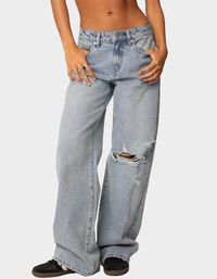 Add Some Edge To Your Closet With These Distressed Jeans, Featuring A Wide Leg For That Extra Element Of Grunge. Paired With A Cute Tee, You'll Always Feel Like The Ultimate Cool Girl. Jeans. Mid Rise Waist. Wide Leg Fit. Distressed Denim Fabric. 100% Cotton. Model Wears Size S. Model Height Is 5'8. Item Care: Machine Wash At Maximum Of 30ºc, Do Not Bleach, Tumble Dry Low, Iron At A Maximum Of 110ºc, Do Not Dry Clean. | Edikted Adam Distressed Wide Leg Jeans